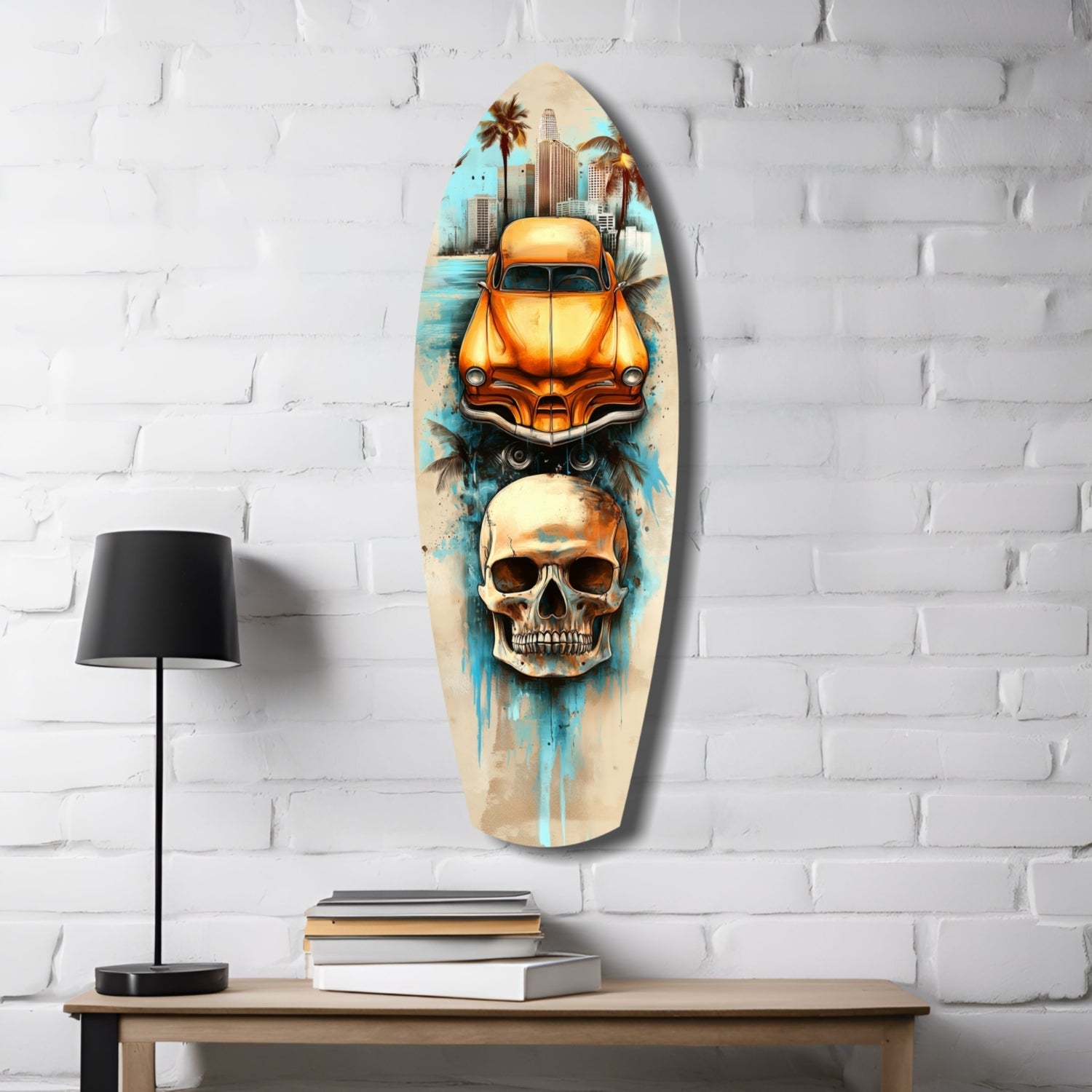 Surfboard-shaped glass wall art displaying orange vintage car, skull, and cityscape against white brick, styled on wooden desk with lamp and books.