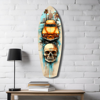 Surfboard-shaped glass wall art displaying orange vintage car, skull, and cityscape against white brick, styled on wooden desk with lamp and books.