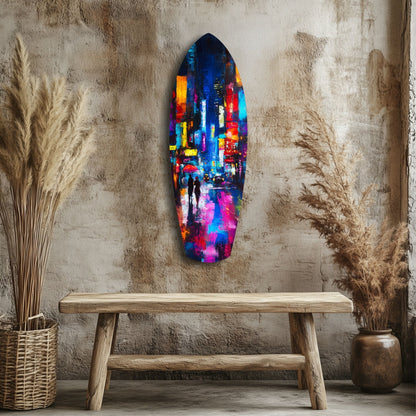 Colorful glass wall art depicting a neon-lit cityscape with two figures, hung above a wooden bench in a minimalist room with dried grasses.
