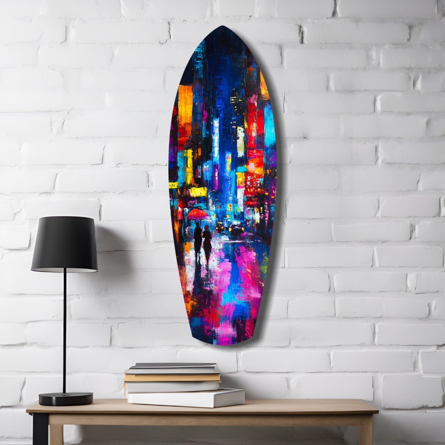 Colorful glass surfboard art displaying a vibrant city street scene hangs on white brick wall above wooden desk with lamp and books.