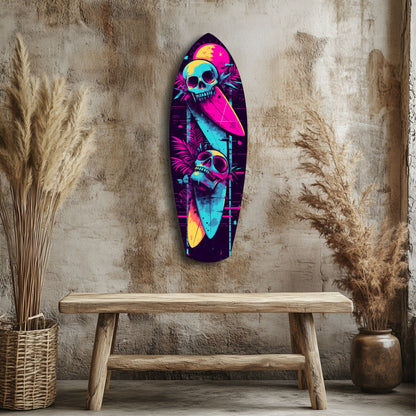 Neon skull surfboard glass wall art displayed above wooden bench against textured beige wall with dried pampas grass.