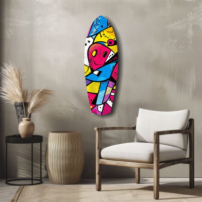 Colorful geometric glass wall art with pink, blue, yellow, and white sections displayed in a modern living room setting with wooden chair and neutral decor.