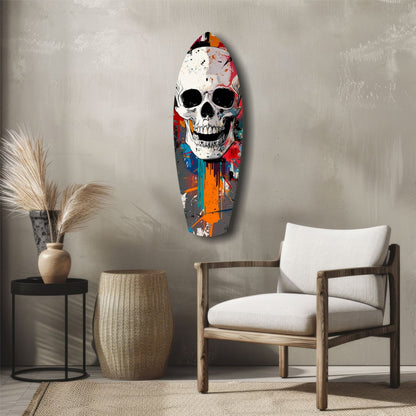 Colorful street art skull glass wall art hanging above a wooden chair in a minimalist interior setting.