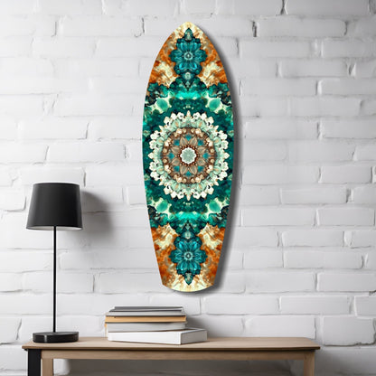 Oval glass wall art with teal, emerald, and orange kaleidoscopic floral design displayed above wooden desk with lamp and books.