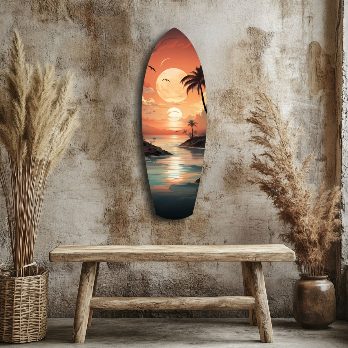 Surfboard-shaped glass wall art displaying a tropical sunset scene with palm trees and ocean, hung on textured wall above wooden bench with dried pampas grass.