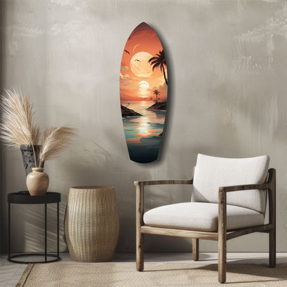 Surfboard-shaped glass wall art displaying a tropical sunset with palm trees, moon, and ocean in warm orange and teal tones, displayed in a minimalist room setting.