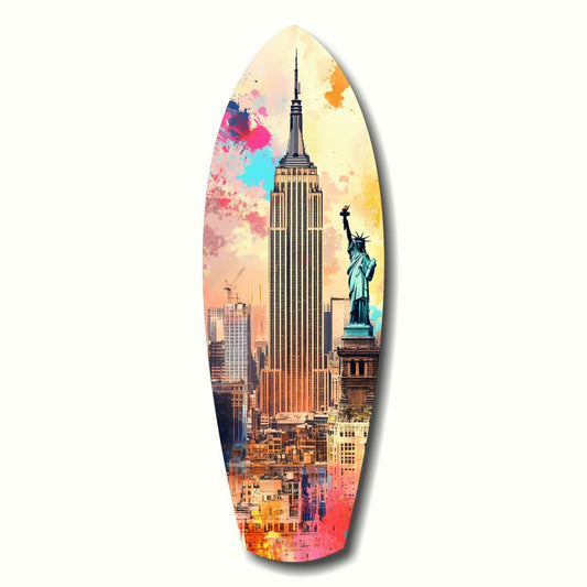 Surfboard-shaped glass art featuring Empire State Building and Statue of Liberty with watercolor splashes in pink, blue, and orange tones.
