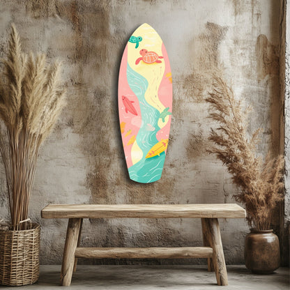 Colorful surfboard-shaped wall art with sea turtles and ocean waves displayed above a wooden bench against a textured concrete wall.