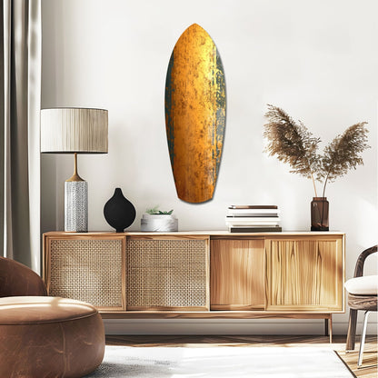Golden oval glass wall art with textured amber and dark patina finish displayed above mid-century wooden credenza in modern interior.