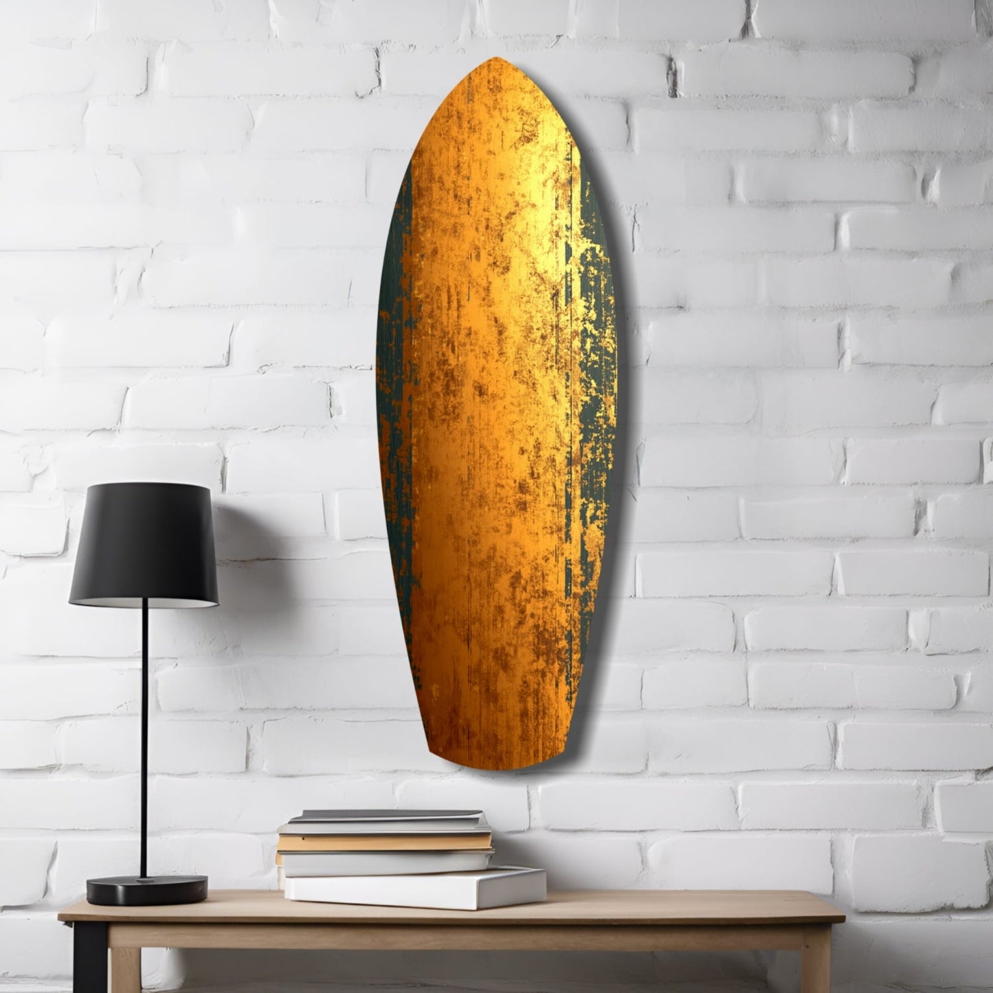 Golden Plate Glass Wall Art mounted on white brick above wooden table with black lamp and stacked books.