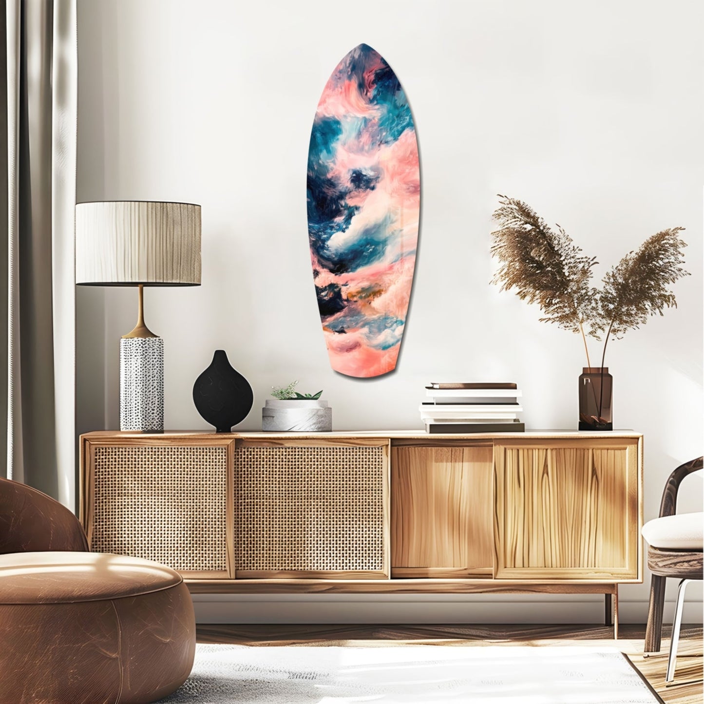 Surfboard-shaped glass wall art with pink, blue, and teal abstract cloud patterns displayed above a wooden mid-century credenza in a modern living room.