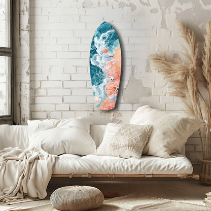 Eternal Tides glass wall art displayed above a cream-upholstered daybed, featuring teal and coral ocean wave designs with small skull motifs.