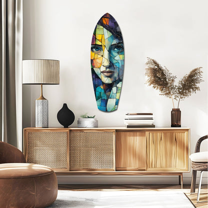 Colorful stained glass wall art featuring abstract fragmented face with blue, yellow, and orange geometric pieces displayed above wooden mid-century console in modern living room.