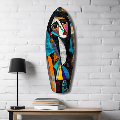 Cubist Muse Glass Wall Art hung on white brick wall above wooden desk with lamp and stacked books, featuring colorful geometric female portrait.
