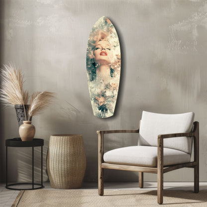 Oval glass wall art featuring a blonde woman's portrait with floral overlay, displayed above wooden chair in minimalist room setting.