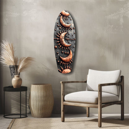 Black and copper Lunar Order glass wall art featuring three crescent moons with radiating stars, displayed above a wooden chair in a minimalist interior setting.