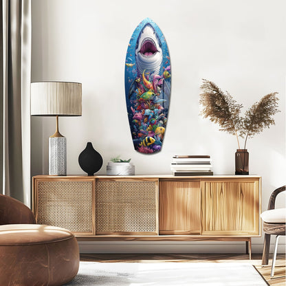 Shark surfboard wall art with vibrant coral reef and tropical fish design displayed above mid-century wooden sideboard in modern living room.