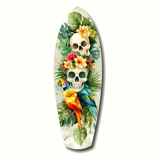 Surfboard-shaped glass wall art featuring two stacked skulls surrounded by tropical flowers, green foliage, and a colorful parrot on cream background.