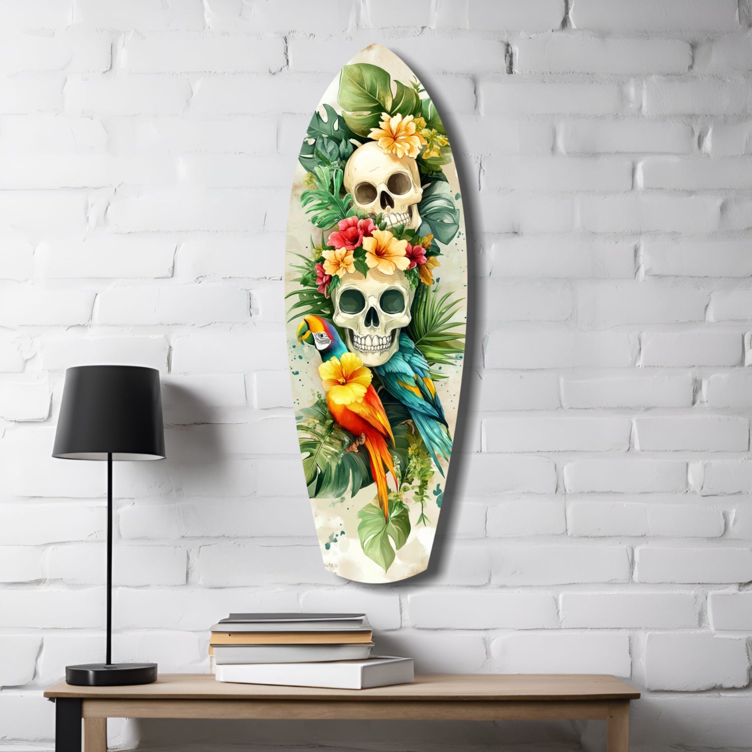 Oval glass wall art featuring two skulls surrounded by tropical flowers, parrots, and green foliage on white brick wall above wooden desk.