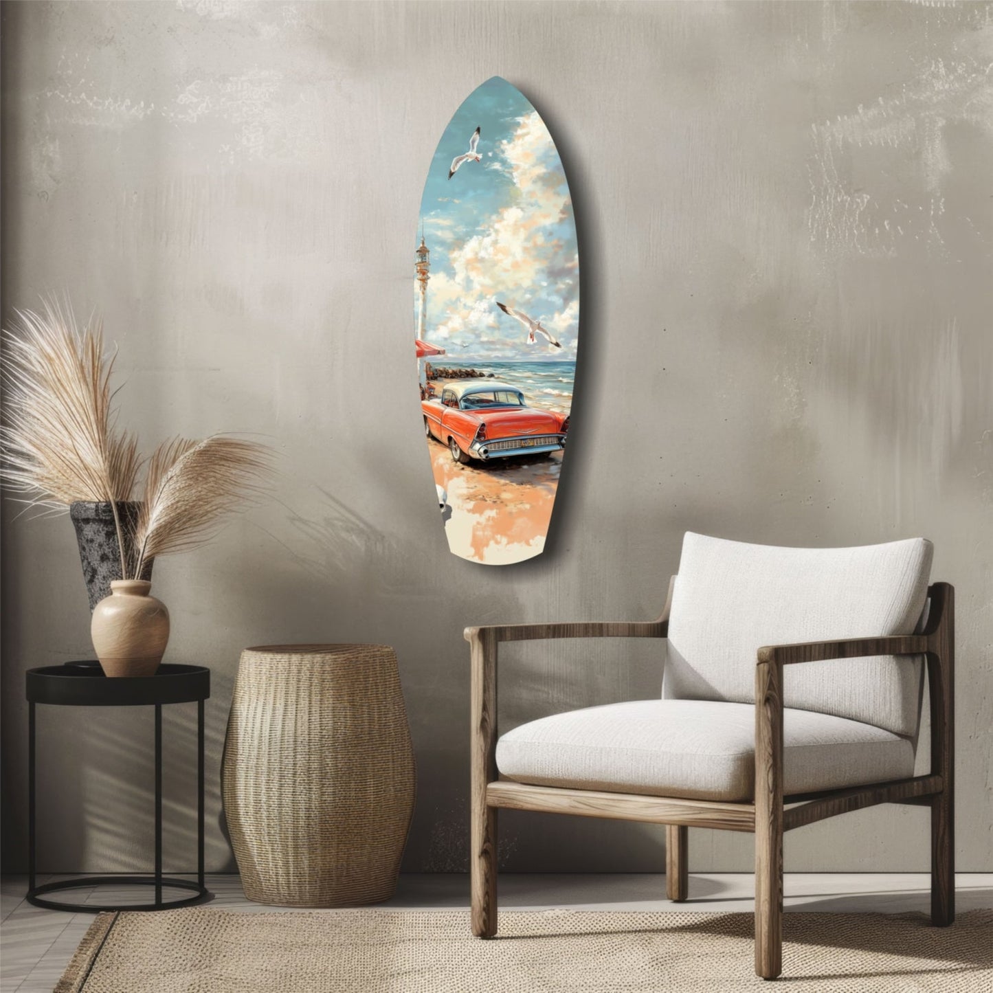 Surfboard-shaped glass wall art depicting a red vintage car on a beach with lighthouse, displayed above wooden chair and side table in modern interior.