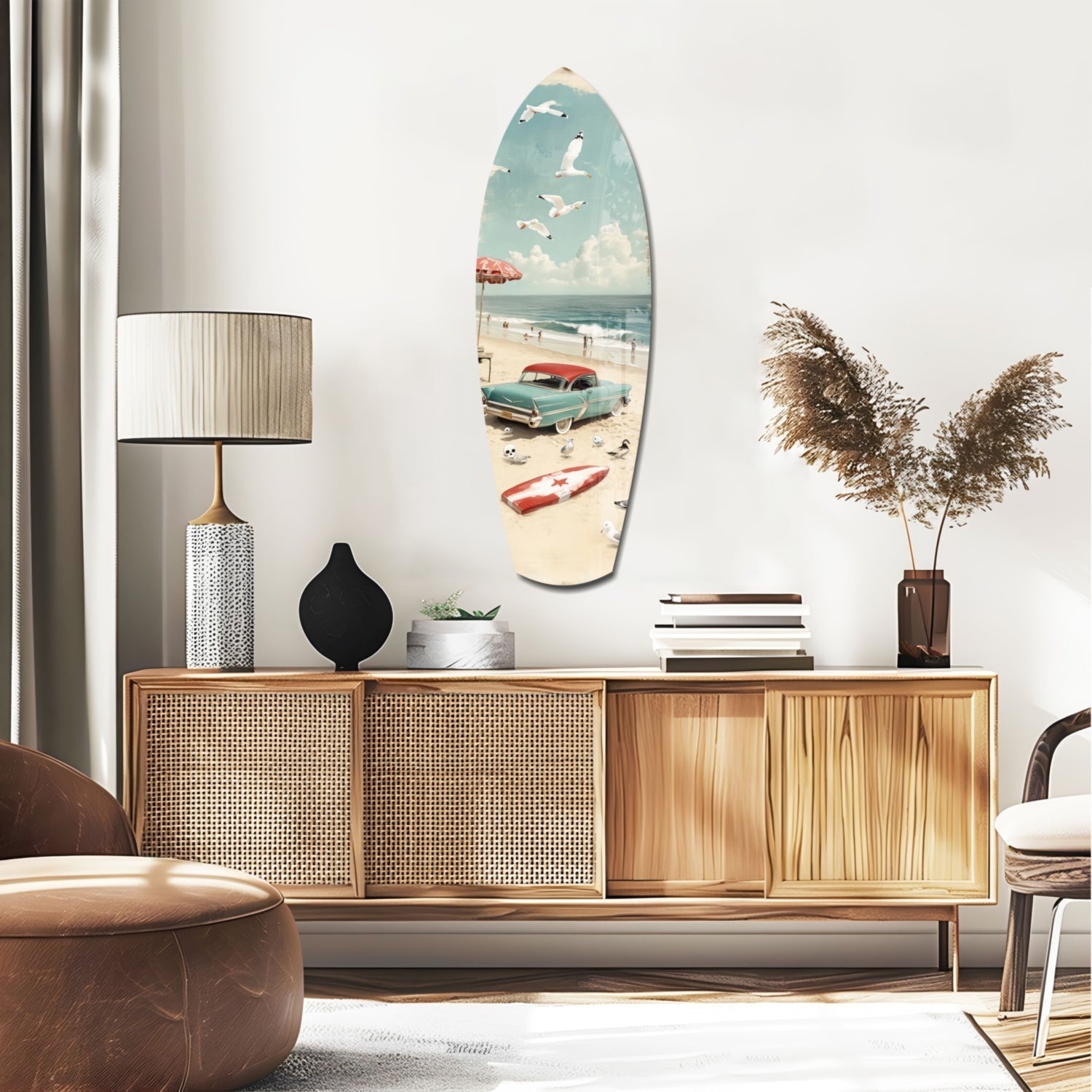 Surfboard-shaped glass wall art depicting a vintage beach scene with turquoise car, umbrella, and sailboat hung above a wooden credenza.