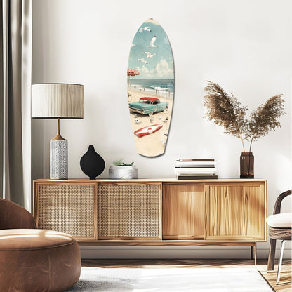 Surfboard-shaped glass wall art depicting a vintage beach scene with turquoise car, umbrella, and sailboat hung above a wooden credenza.