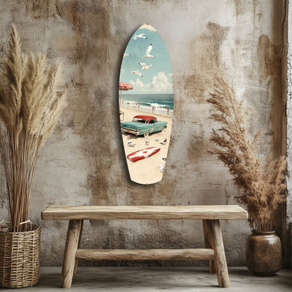 Surfboard-shaped glass wall art depicting a vintage beach scene with turquoise car, umbrella, and sailboat, displayed above wooden bench.