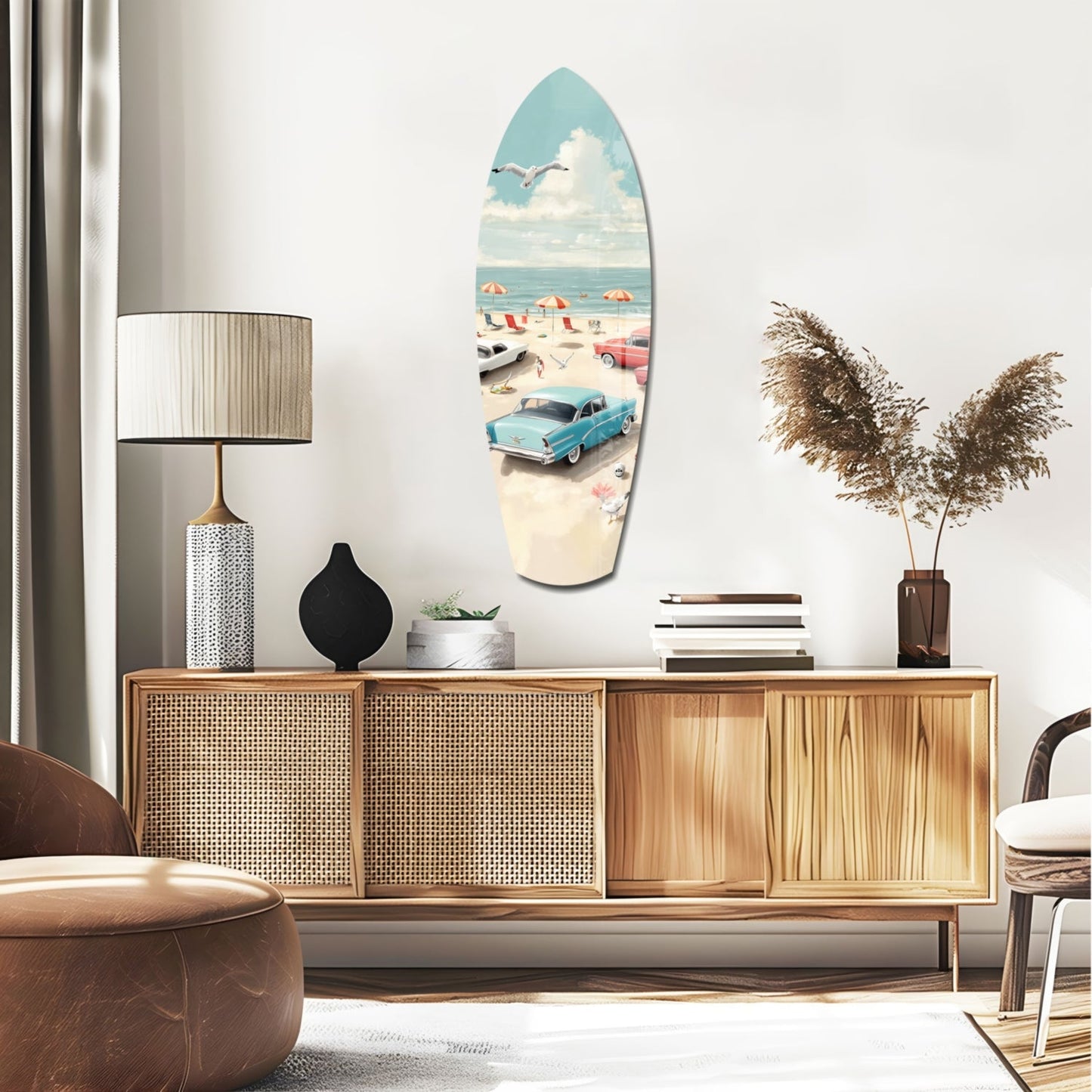 Surfboard-shaped glass wall art depicting a vintage beach scene with turquoise car, umbrellas, and ocean, displayed above a mid-century wooden sideboard.