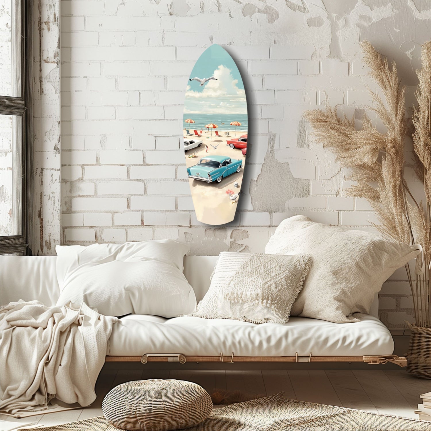 Surfboard-shaped glass wall art depicting a vintage 1950s beach scene with turquoise car, umbrellas, and ocean, displayed above a cream linen sofa.