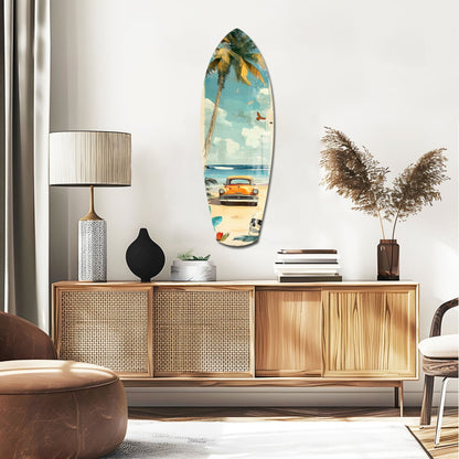 Surfboard-shaped glass wall art depicting vintage beach scene with orange car, palm tree, and blue sky, displayed above wooden mid-century credenza in modern living room.