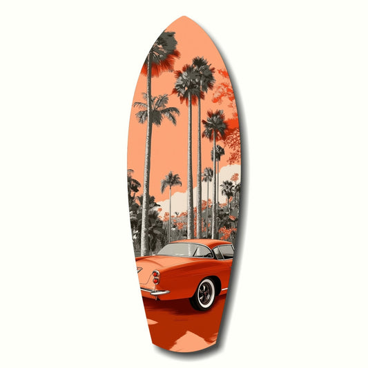 Surfboard-shaped glass art featuring a red vintage car beneath tall palm trees against an orange sunset sky.
