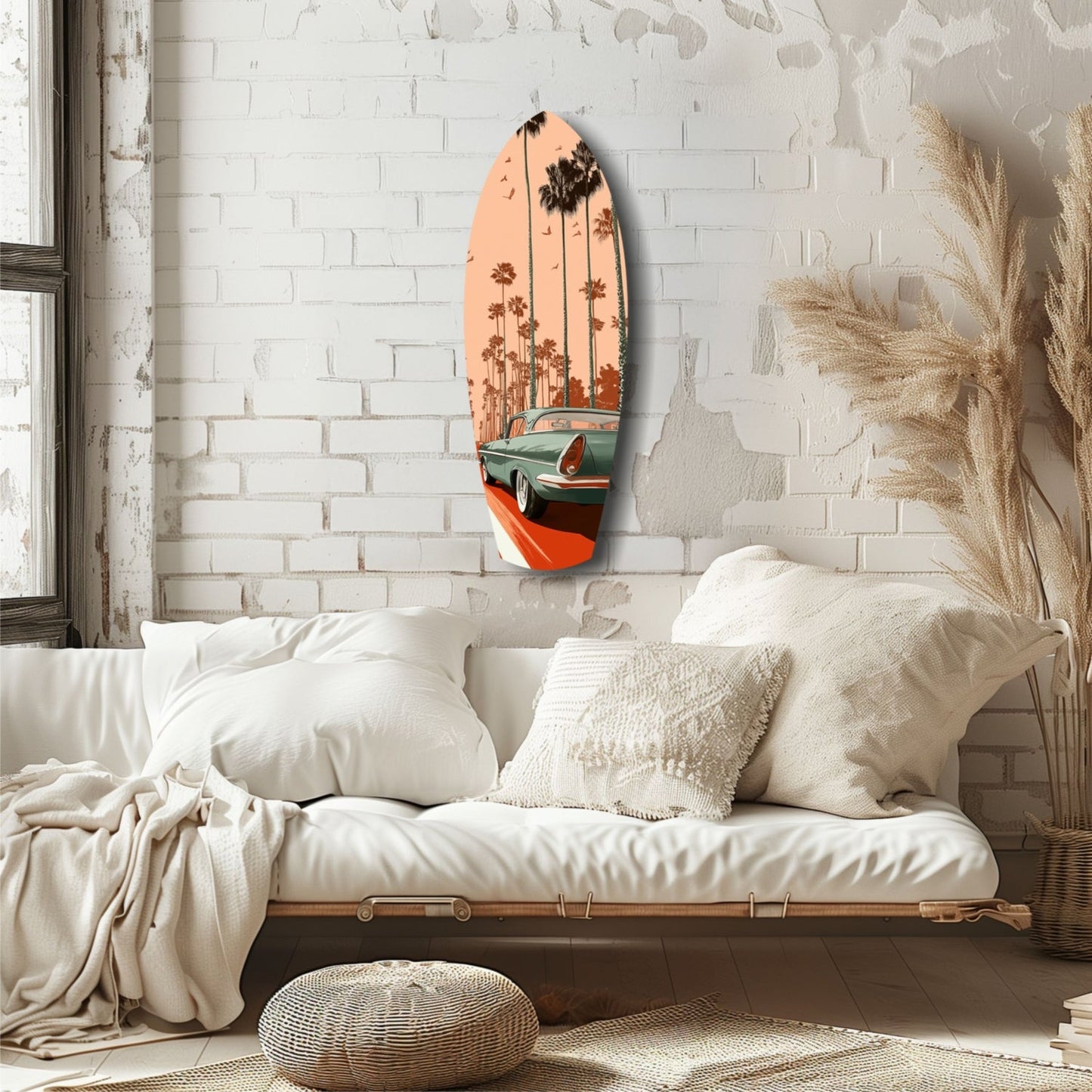 Surfboard-shaped glass art with orange sunset, palm trees, and vintage car displayed on white brick bedroom wall above cream bedding.