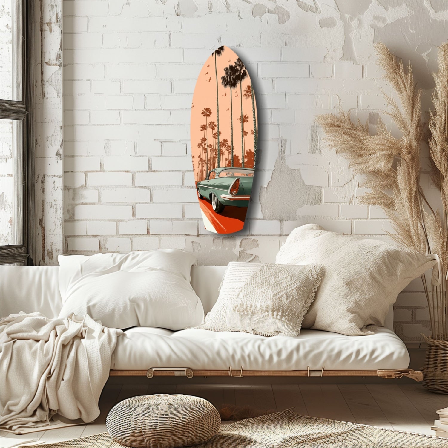 Surfboard-shaped glass art with orange sunset, palm trees, and vintage car displayed on white brick bedroom wall above cream bedding.