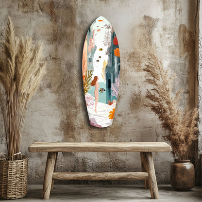 Oval glass wall art depicting an underwater seascape with a woman, colorful fish, and coral in orange, teal, and pink tones, displayed above a wooden bench.