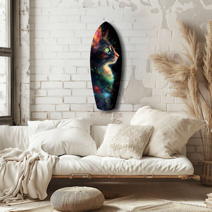 Colorful celestial cat glass wall art hung above a white bedding setup in a minimalist brick bedroom.