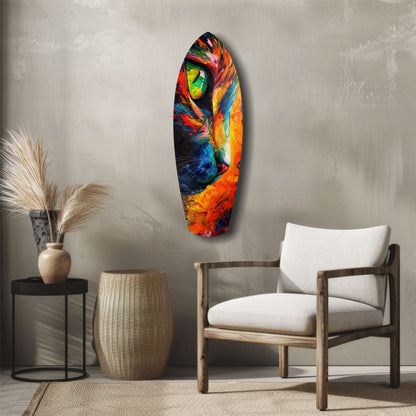 Colorful glass wall art featuring a vibrant cat's face with orange, red, blue, and yellow hues displayed in a minimalist interior setting.