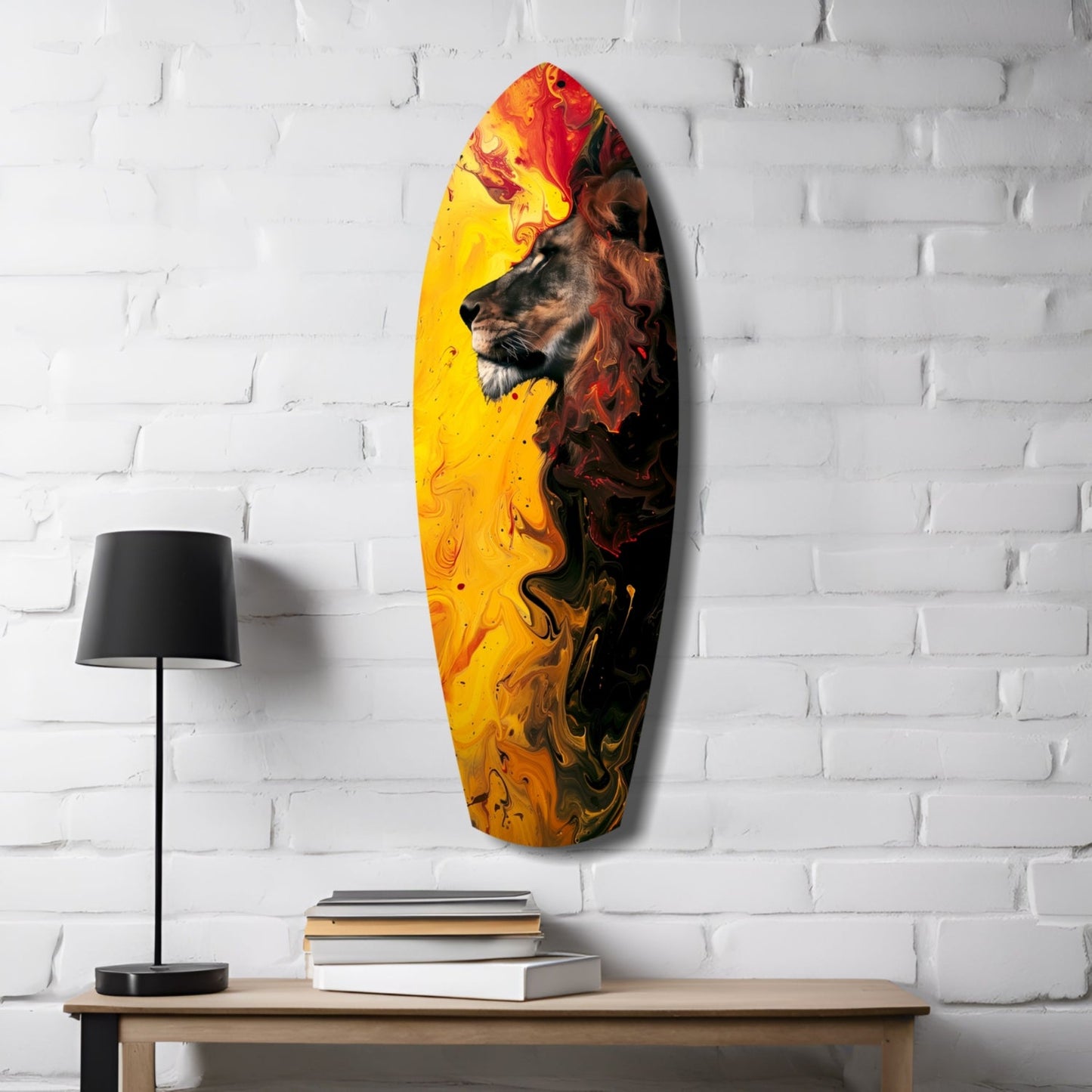 Lion Pride V3 glass wall art displayed on white brick wall above wooden table with lamp and books, featuring lion profile in yellow, orange, and red swirling colors.