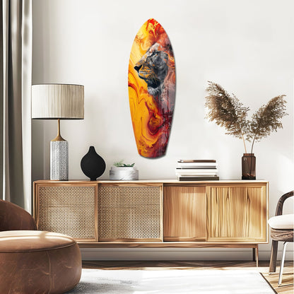 Lion Pride V7 glass wall art displaying a lion's head in orange, yellow, and red flame-like colors, hung above a wooden sideboard in a modern interior setting.