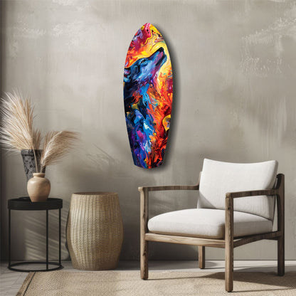 Colorful glass surfboard wall art featuring a blue wolf howling amid vibrant red, orange, and yellow flames, displayed in a minimalist room setting.