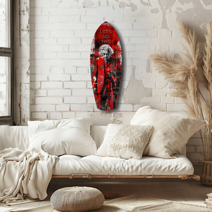 Red glass wall art with Einstein figure and "Let's Do This" text displayed above a white bed in a minimalist bedroom.