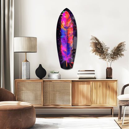 Colorful feather glass wall art with vibrant pink, orange, and blue gradient displayed above a wooden credenza in a modern living room setting.