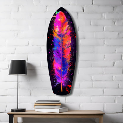 Vibrant neon feather glass wall art in magenta, orange, and blue displayed on white brick with lamp and books.