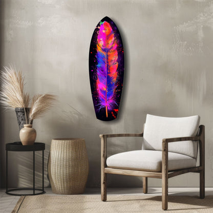 Colorful feather glass wall art with vibrant neon pink, orange, purple, and blue hues displayed above a wooden chair in a minimalist room setting.