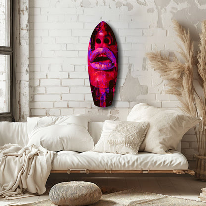 Vibrant red and pink lips glass wall art mounted above a cream-colored daybed with pillows and pampas grass decor.