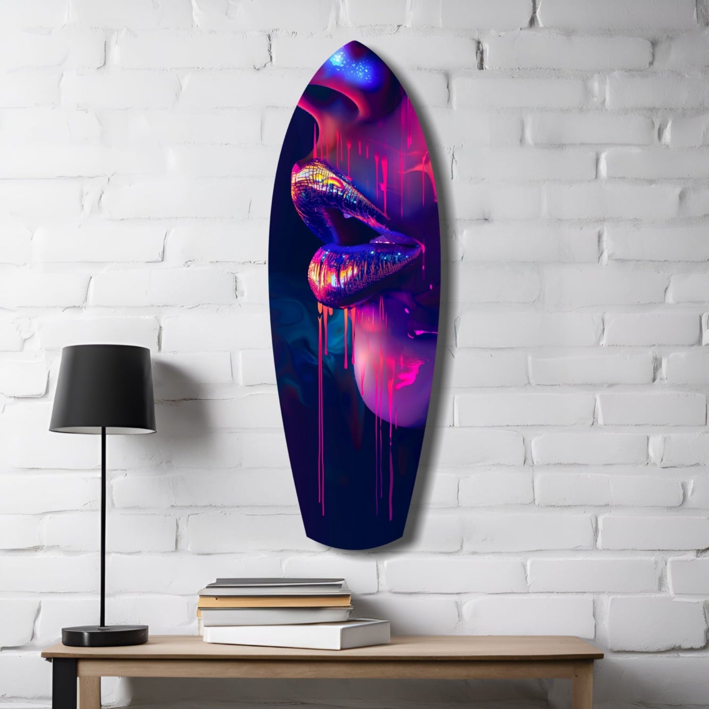 Neon lips glass wall art in vibrant pink, purple, and blue tones hanging on white brick wall above wooden desk with lamp and books.