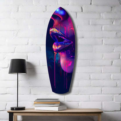 Neon lips glass wall art in vibrant pink, purple, and blue tones hanging on white brick wall above wooden desk with lamp and books.