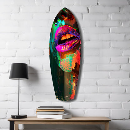 Vibrant neon pop art glass wall sculpture featuring colorful lips displayed on white brick wall above wooden table with lamp and books.
