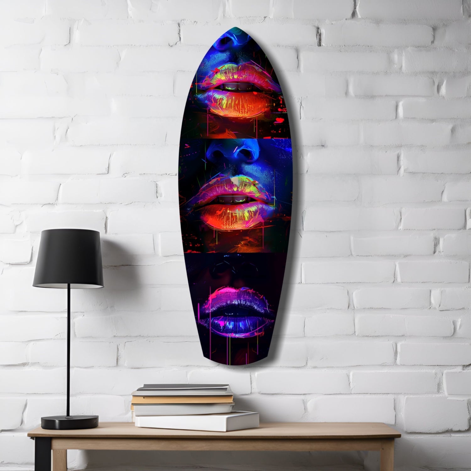 Neon lips glass wall art in vibrant red, blue, and pink displayed on white brick wall above wooden desk with lamp and books.
