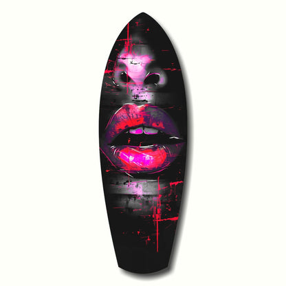 Black surfboard-shaped glass art with neon pink and magenta glowing lips and face on dark background.