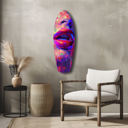 Vibrant neon lips glass wall art mounted on neutral wall above wooden chair and decorative side table.